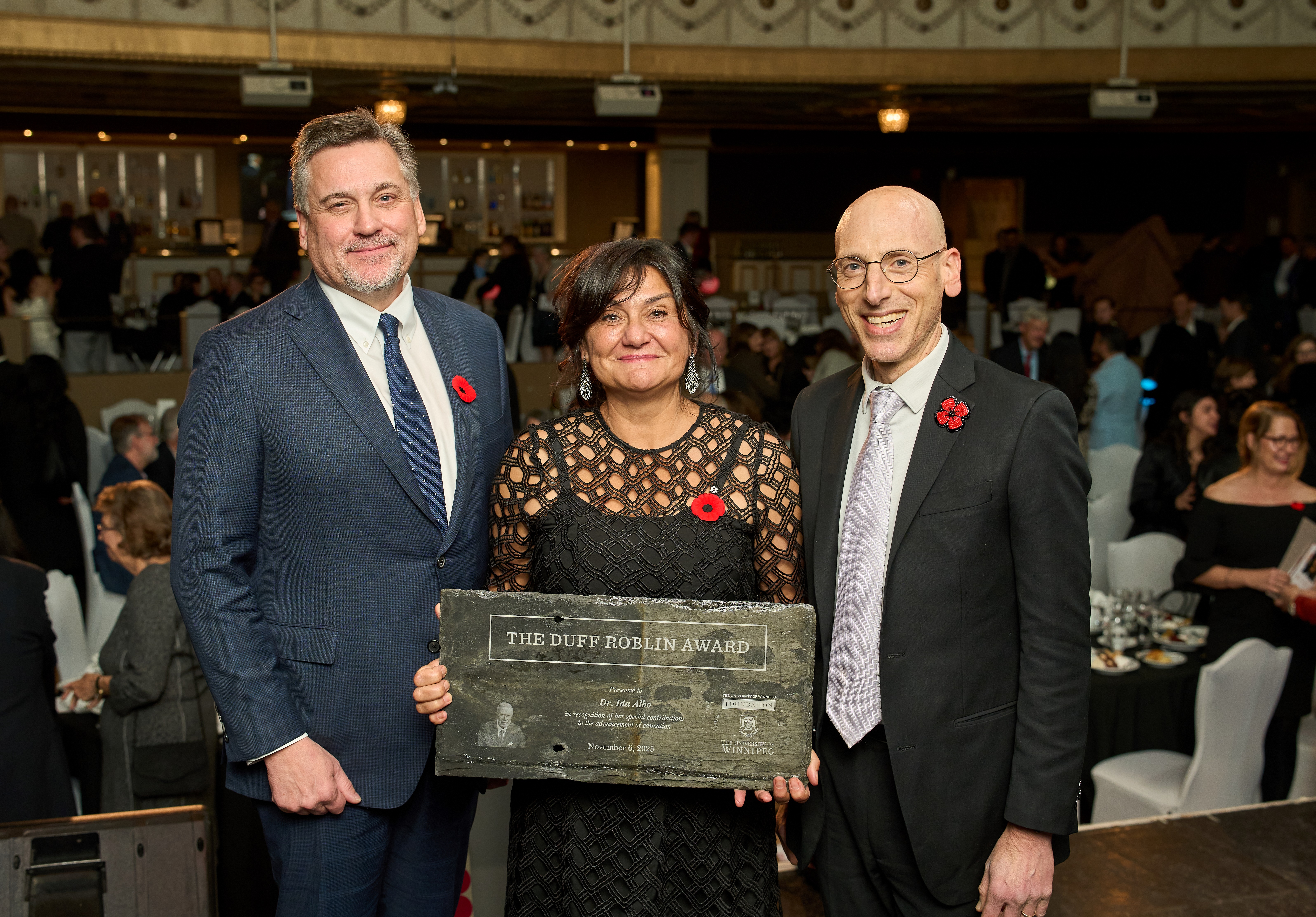 Javier Schwersensky, President and CEO of the UWF joins Dr. Todd Mondor, President and Vice-Chancellor of UWinnipeg to present Dr. Albo with the Duff Roblin Award